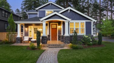 A global home with a blue exterior and a walkway.