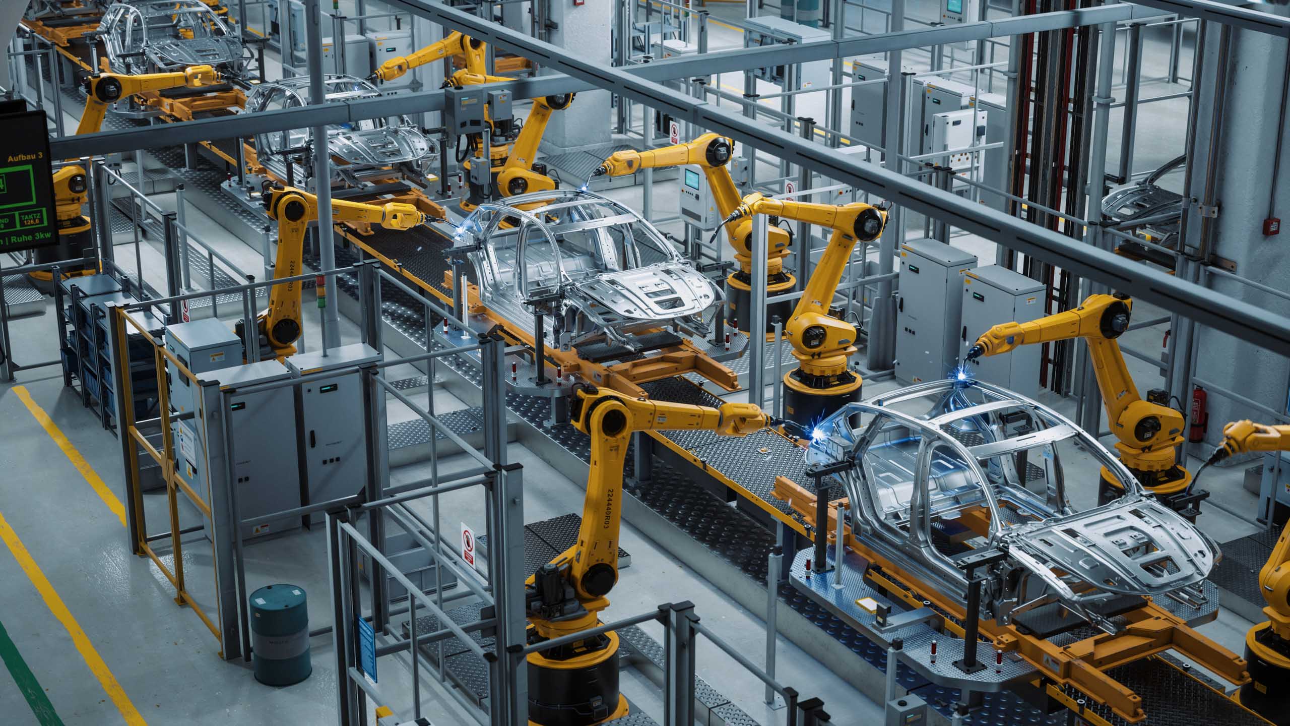 A strategic tech company operating a factory with robots working on cars.