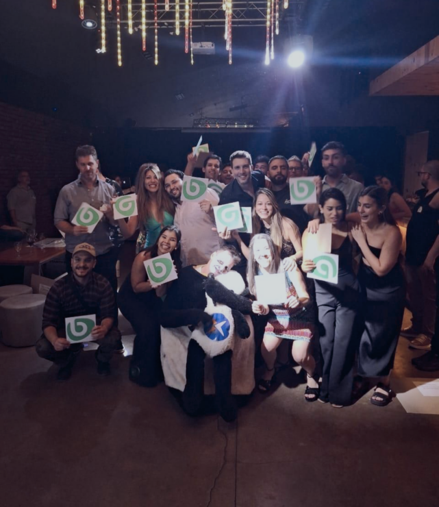 A group of people holding signs at a careers party.