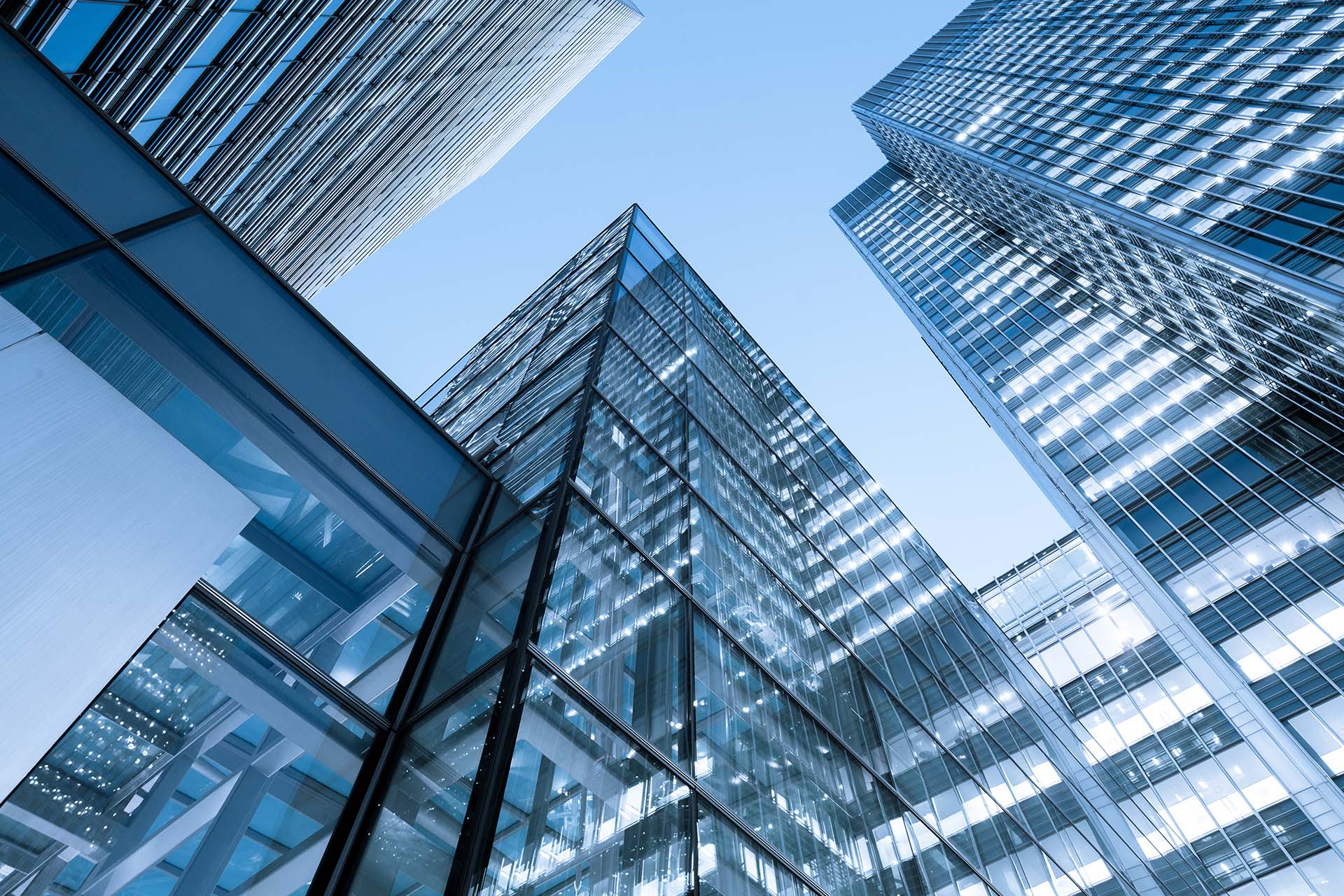 London skyscrapers with glass windows and blue sky.